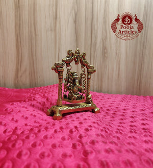 Premium Brass Ganesha on Jhula Swing Statue 4.2 Inch - Right three-quarter view showing peacock arch detailing