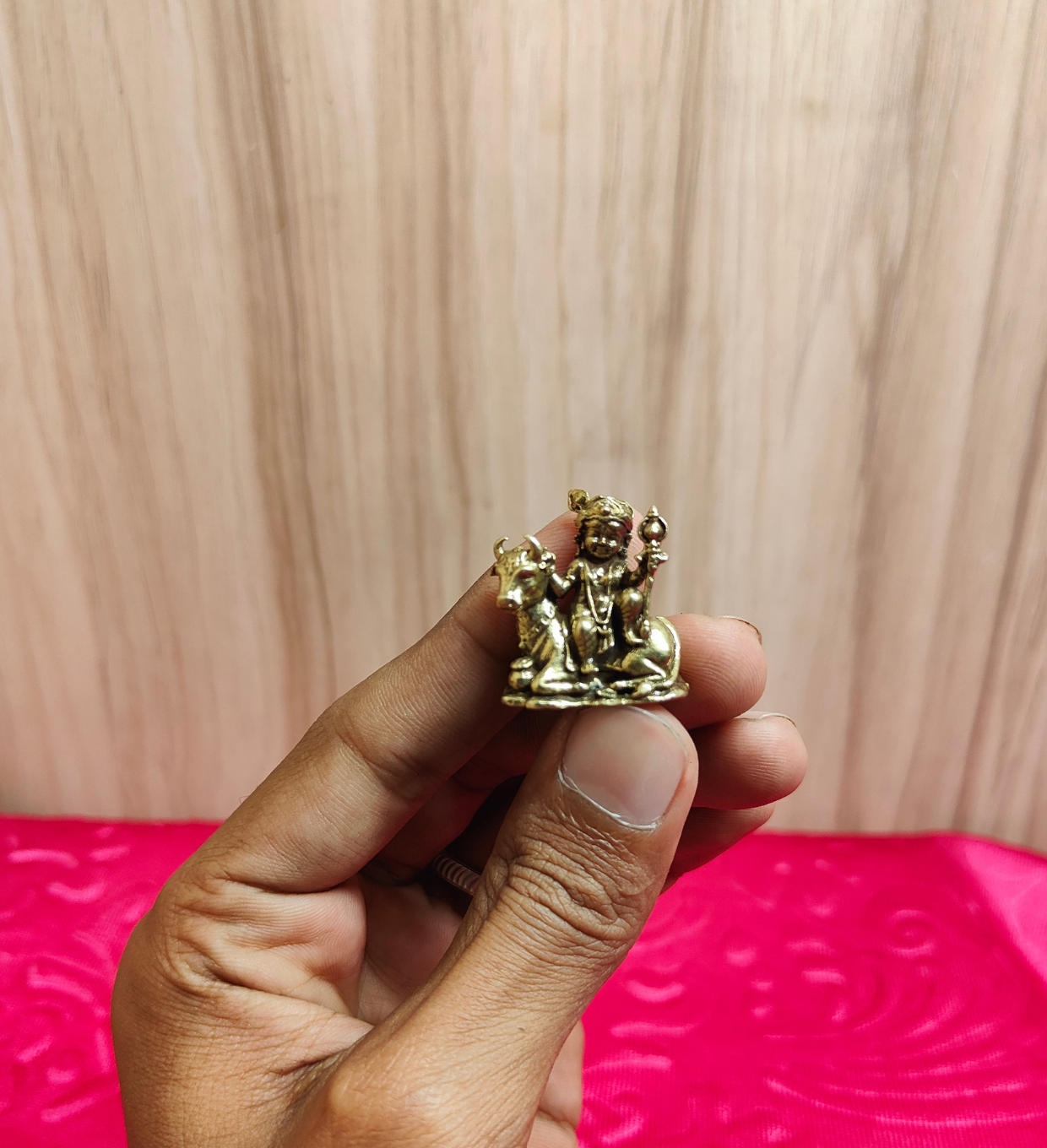 Brass Miniature Lord Krishna with Kamadhenu Cow 1 Inch - Hand Scale View